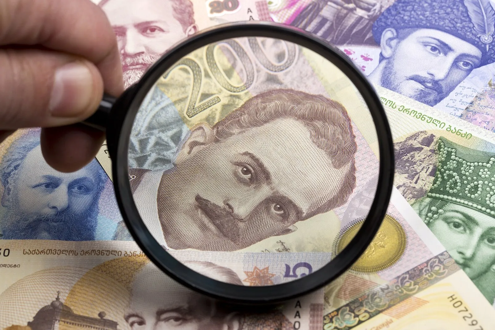 georgian lari in a magnifying glass 58N887W новости