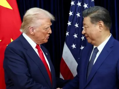 Donald Trump and Xi Jinping pictured shaking hands in front of a Chinese flag and a US flag