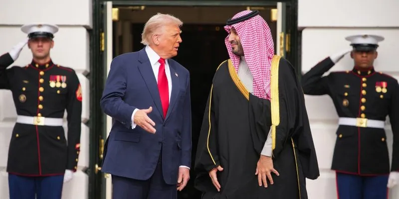 A file picture of Saudi Crown Prince Mohammed bin Salman and Donald Trump standing outside White House, behind them are two men in uniform saluting
